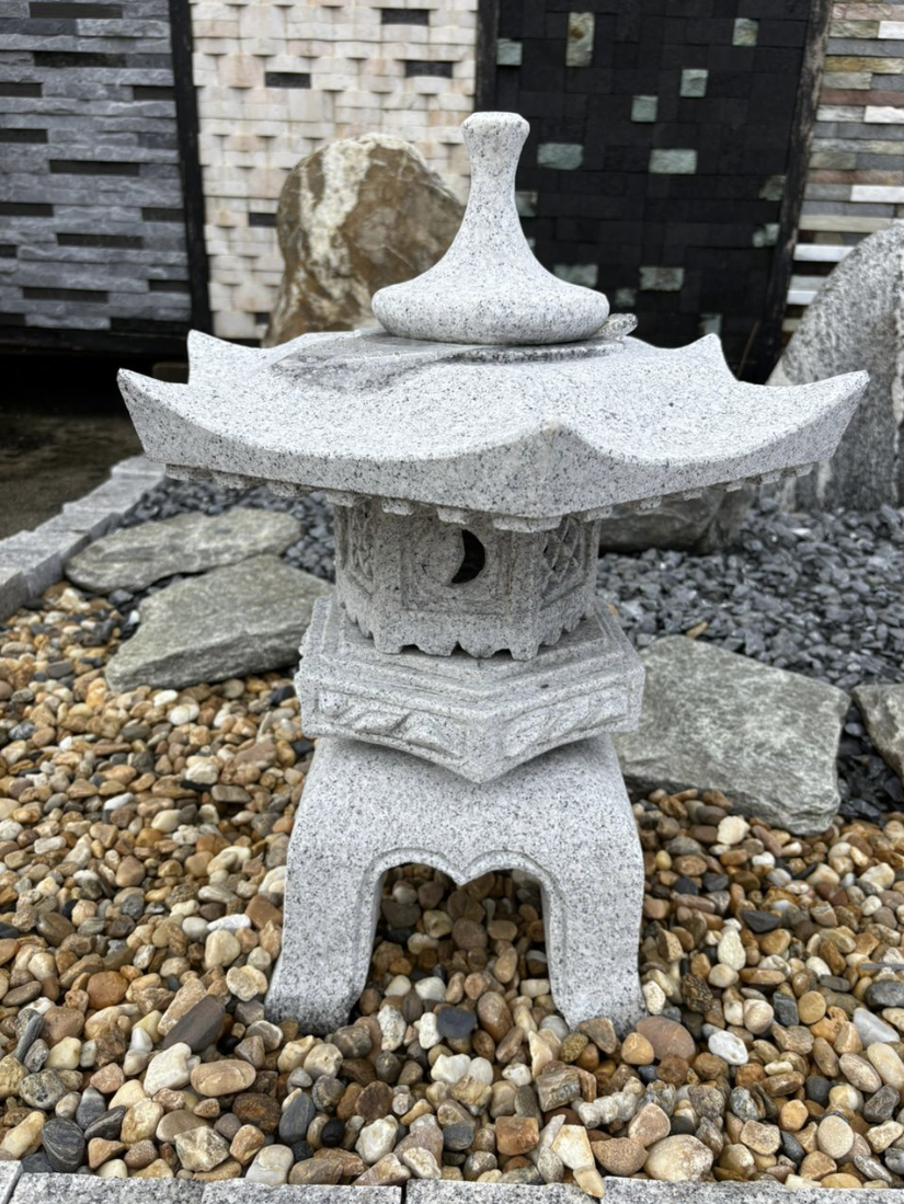 Carved granite Japanese stone lantern garden ornament in a pebble courtyard, supplied by GP FloraL